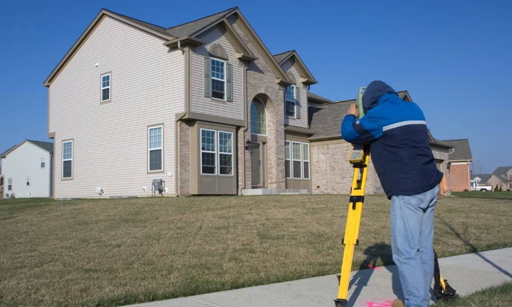 North dakota elevation certificate surveyor - ALTA SURVEY North Dakota Surveyor measuring beside a North Dakota residential home for elevation certificate information